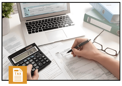 Person calculating tax registration details with forms, calculator, and laptop on a desk.